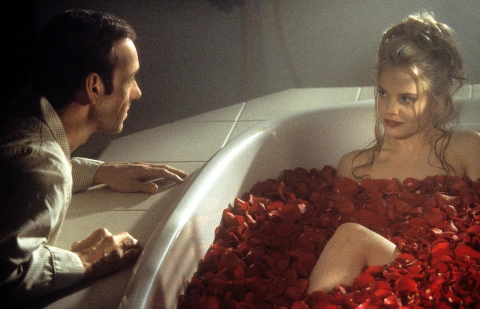 PHOTO: Kevin Spacey looks at Mena Suvari as she bathes in rose pedals in a scene from the 1999 film 'American Beauty.' (DreamWorks SKG/Hulton Archive via Getty Images)