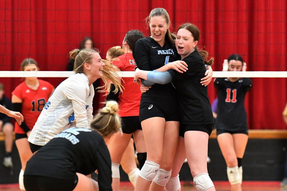 Mercy volleyball team members celebrate after winning the Sixth Region championship. Mercy advanced to the state quarterfinals after defeating Central Hardin on Monday night.