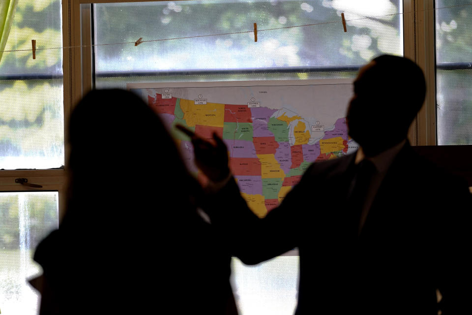 Romian Crockett, Principle of Chalmers Elementary school, right, talks with a Chalkbeat reporter Mila Koumpilova at Chalmers Elementary school in Chicago, Wednesday, July 13, 2022. America's big cities are seeing their schools shrink, with more and more of their schools serving small numbers of students. Those small schools are expensive to run and often still can't offer everything students need (now more than ever), like nurses and music programs. Chicago and New York City are among the places that have spent COVID relief money to keep schools open, prioritizing stability for students and families. But that has come with tradeoffs. And as federal funds dry up and enrollment falls, it may not be enough to prevent districts from closing schools. (AP Photo/Nam Y. Huh)