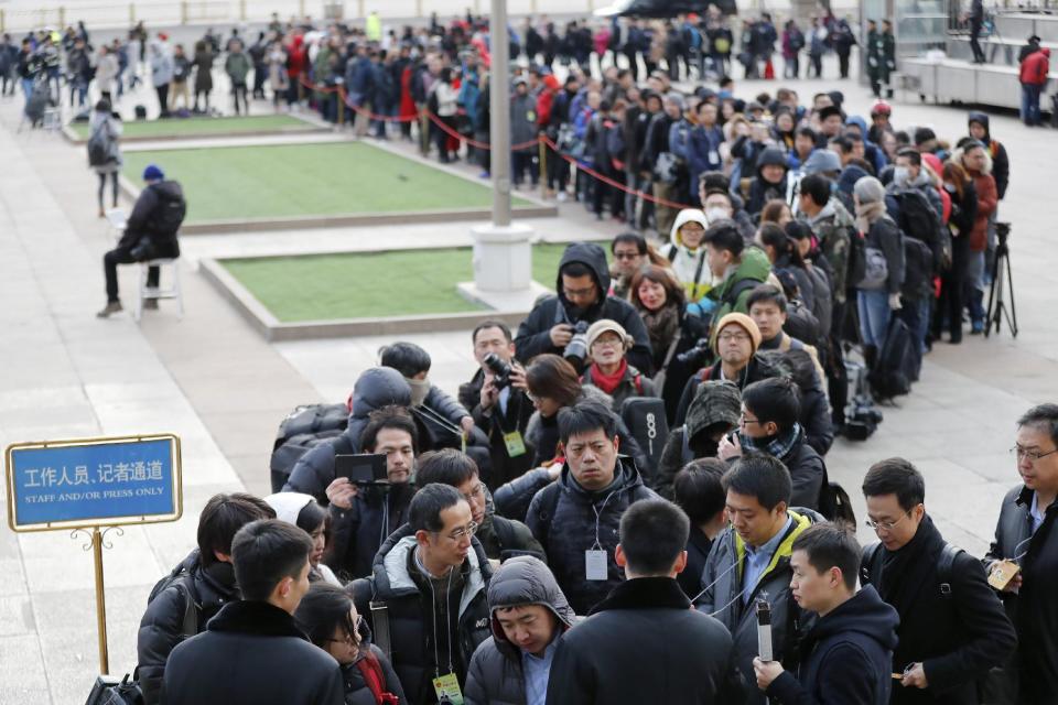 Local and foreign journalists line up to enter the Great Hall of the People to cover the opening session of the annual National People's Congress in Beijing, Sunday, March 5, 2017. China's top leadership as well as thousands of delegates from around the country are gathered at the Chinese capital for the annual legislature meetings. (AP Photo/Andy Wong)