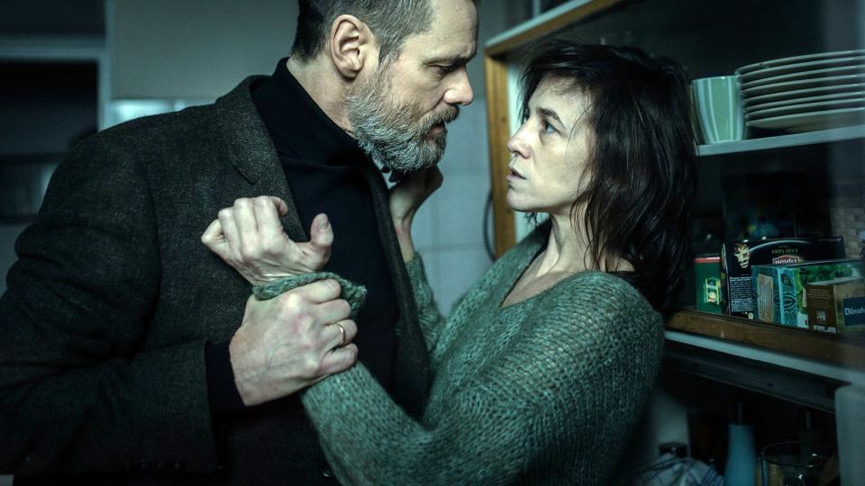 Still from the movie "Dark Crimes" depicting Jim Carrey interrogating Charlotte Gainsbourg in her home