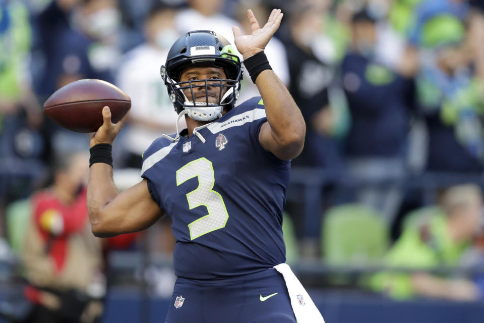 Seattle Seahawks quarterback Russell Wilson warms up for the team's NFL football preseason game against the Los Angeles Chargers, Saturday, Aug. 28, 2021, in Seattle. (AP Photo/John Froschauer)