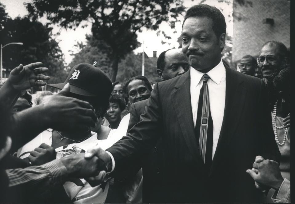 The Reverend Jesse Jackson visits Milwaukee in 1991 and shakes hands with people in a crowd along N. 25th Street during his visit.