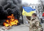 A serviceman from the Aydar battalion waves a Ukrainian flag during a protest against the disbanding of the battalion, in front of Ukraine's Defence Ministry in Kiev, Ukraine, in this February 2, 2015 file photo. REUTERS/Valentyn Ogirenko/Files