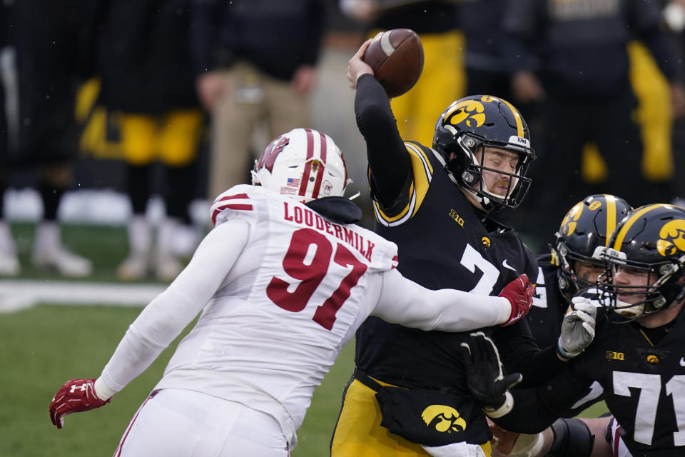 Iowa quarterback Spencer Petras (7) is sacked by Wisconsin defensive end Isaiahh Loudermilk (97) during the first half of an NCAA college football game, Saturday, Dec. 12, 2020, in Iowa City, Iowa. (AP Photo/Charlie Neibergall)