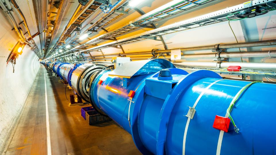 a large metallic pipe in an underground tunnel