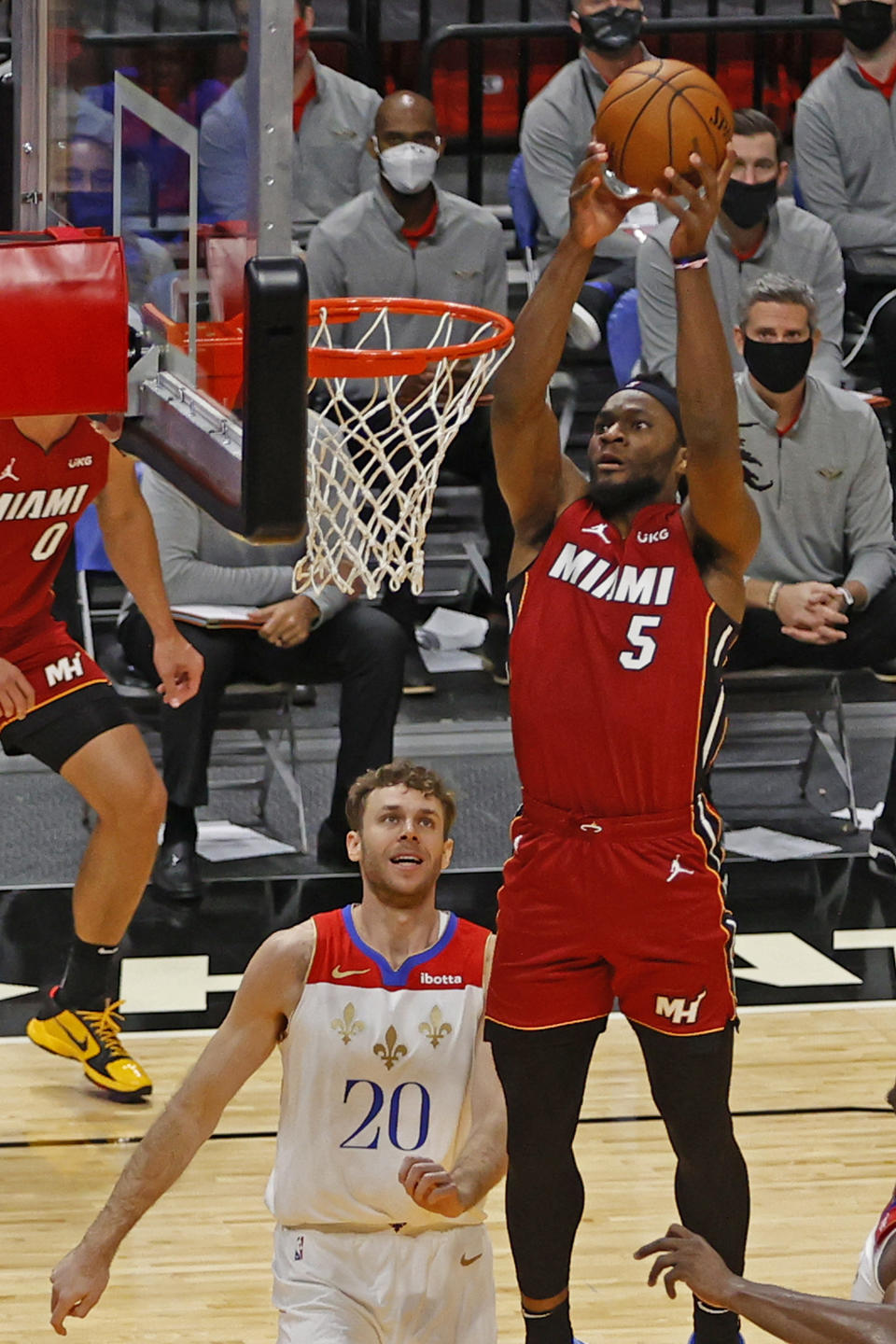 New Orleans Pelicans forward Nicolo Melli (20) looks up as Miami Heat forward Precious Achiuwa (5) goes to the basket during the second half of an NBA basketball game, Friday, Dec. 25, 2020, in Miami. (AP Photo/Joel Auerbach)
