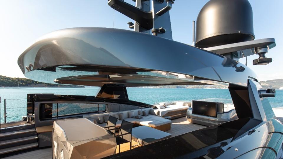 The flybridge is one of the yacht’s social areas, with lounges, a counterflow swimming pool for laps, and a DJ table for parties. - Credit: Courtesy Baglietto
