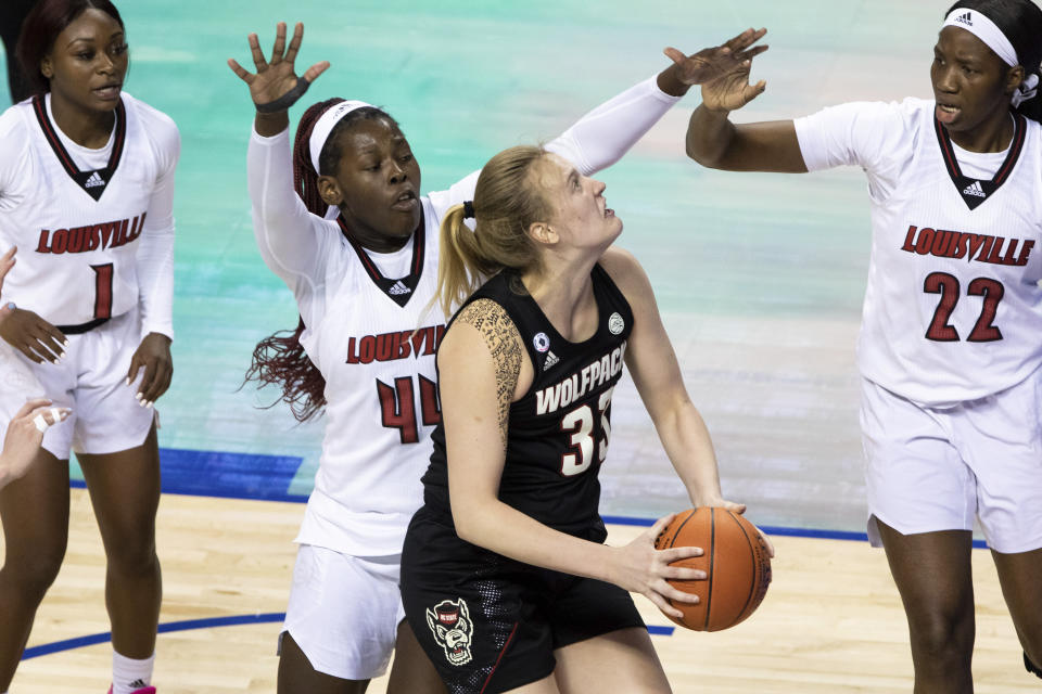 North Carolina State's Elissa Cunane (33) works in the post against Louisville's Olivia Cochran (44) during the championship of Atlantic Coast Conference NCAA women's college basketball game in Greensboro, N.C., Sunday, March 7, 2021. (AP Photo/Ben McKeown)