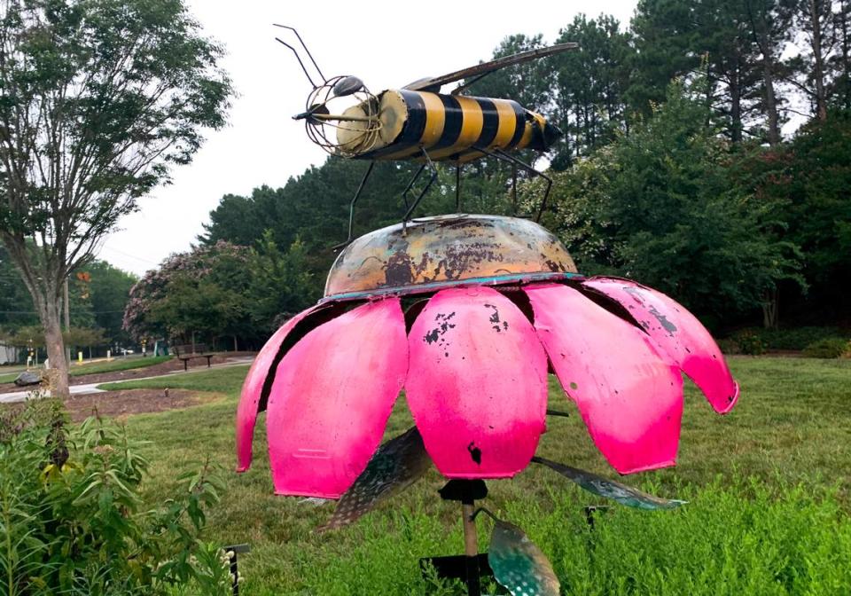 A bee statue stands at a pollinator garden in Matthews on July 26, 2021.