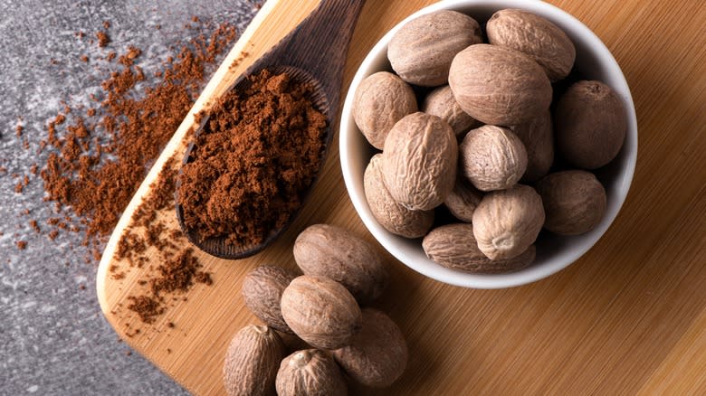 Nutmeg, whole and ground, on surface