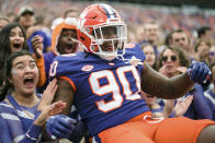 Clemson defensive tackle Jabriel Robinson (90) celebrates with student fans at the start of an NCAA college football game against Louisville, Saturday, Nov. 12, 2022, in Clemson, S.C. (AP Photo/Jacob Kupferman)