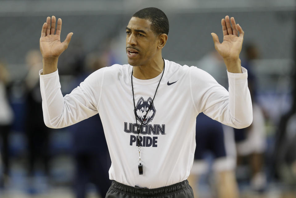 Connecticut head coach Kevin Ollie runs drills during practice for the team's NCAA Final Four tournament college basketball semifinal game Friday, April 4, 2014, in Dallas. Connecticut plays Florida on Saturday, April 5, 2014. (AP Photo/Charlie Neibergall)