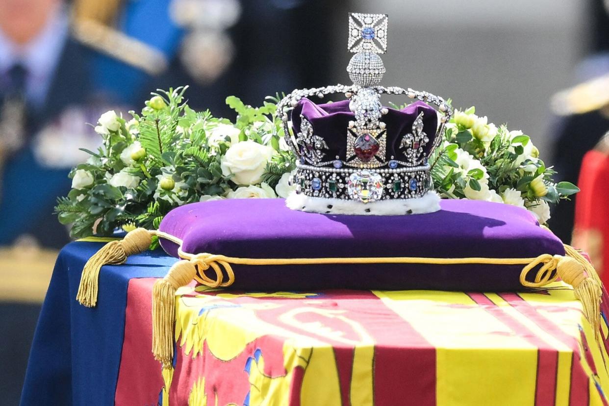 The coffin of Queen Elizabeth II, adorned with a Royal Standard and the Imperial State Crown and pulled by a Gun Carriage of The King's Troop Royal Horse Artillery