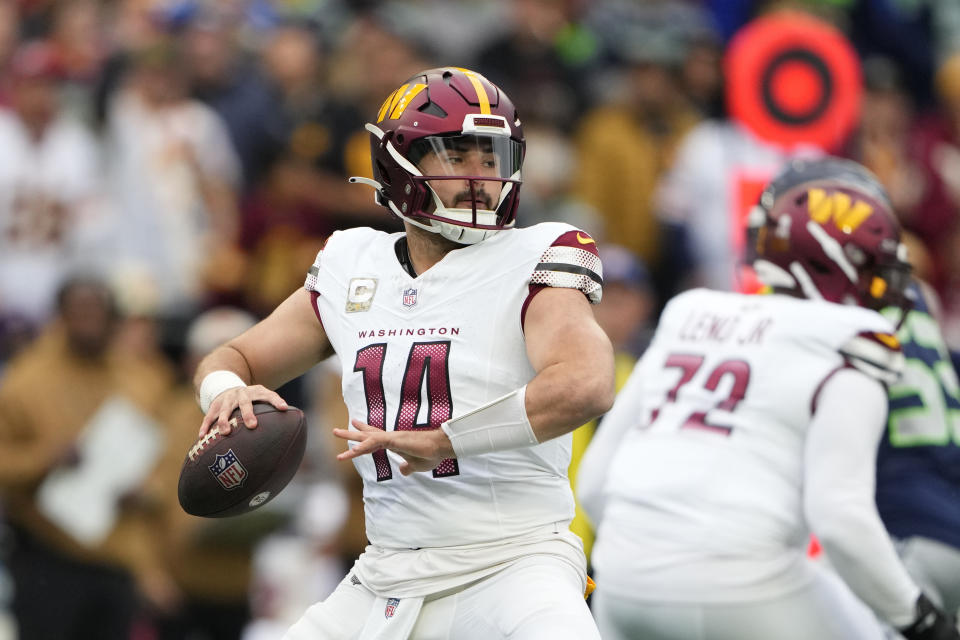 Washington Commanders quarterback Sam Howell (14) sets back to pass in the first half of an NFL football game against Seattle Seahawks in Seattle, Sunday, Nov. 12, 2023. (AP Photo/Lindsey Wasson)