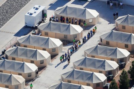 Immigrant children now housed in a tent encampment under the new