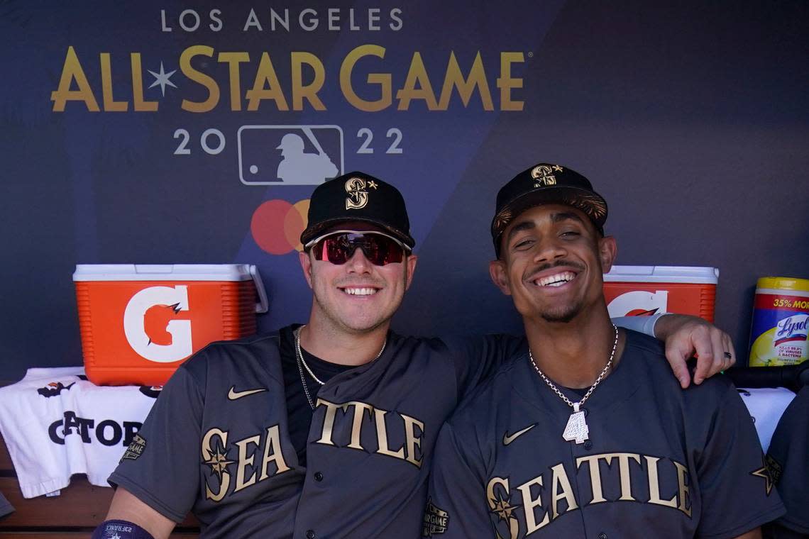 Seattle Mariners’ Ty France and Julio Rodriguez pose for a photo in the dugout during the MLB All-Star baseball game, Tuesday, July 19, 2022, in Los Angeles. (AP Photo/Abbie Parr)