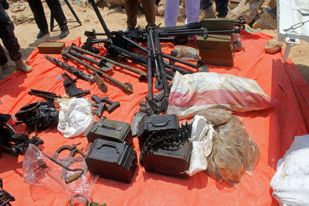 Somali Puntland forces display weapons seized in a boat on the shores of the Gulf of Aden in the city of Bosasso, Puntland region, Somalia September 23, 2017. REUTERS/Abdiqani Hassan