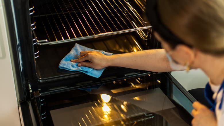 Person cleaning oven