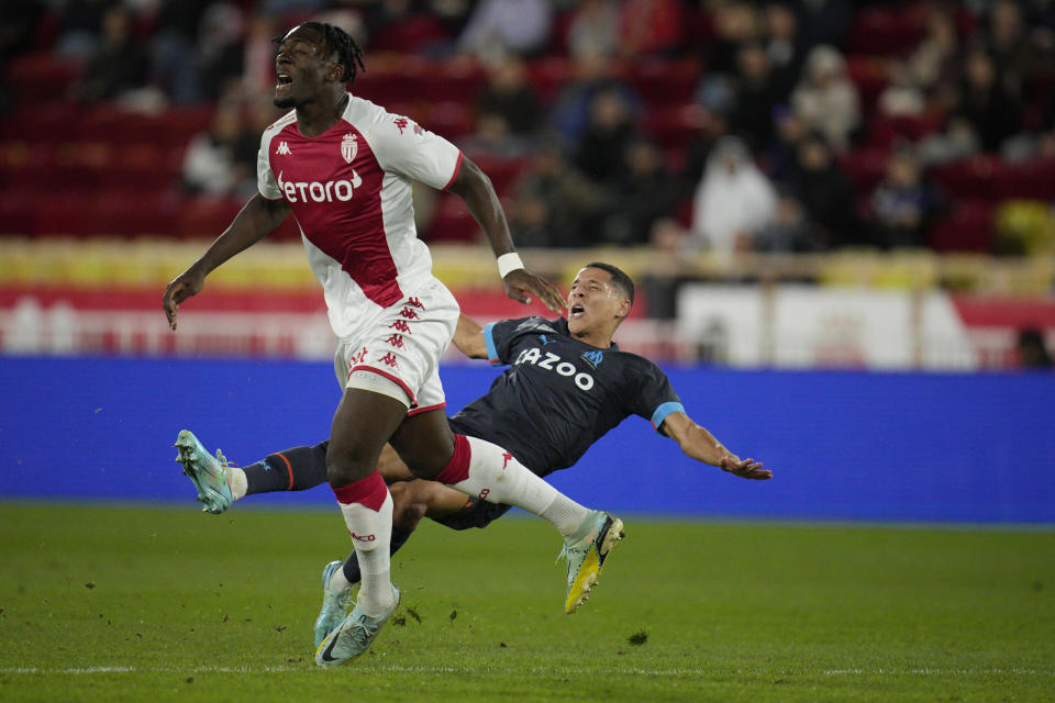 Marseille's Amine Harit, right, and Monaco's Axel Disasi challenge for the ball during the French League One soccer match between Monaco and Marseille at the Stade Louis II in Monaco, Sunday, Nov. 13, 2022. (AP Photo/Daniel Cole)