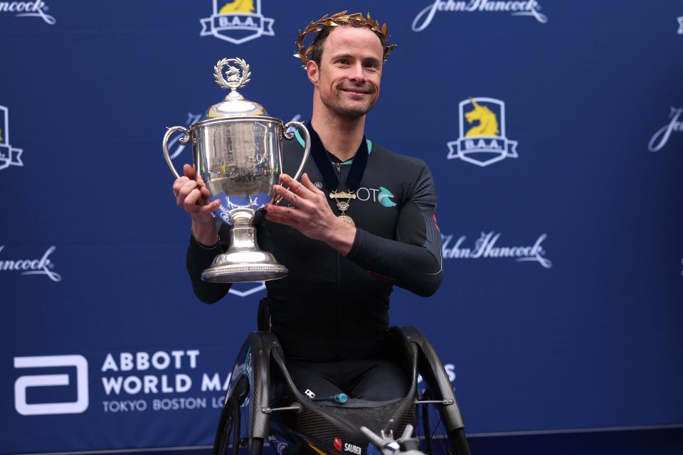 BOSTON, MASSACHUSETTS - APRIL 17: Marcel Hug of Switzerland poses with a the trophy after winning the professional Men's Wheelchair Division during the 127th Boston Marathon on April 17, 2023 in Boston, Massachusetts. (Photo by Maddie Meyer/Getty Images)