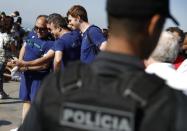 Brazilian police patrol as tourists from Ireland visit the Christ the Redeemer statue on the first day of a massive security operation that they say will last through the end of the Rio 2016 Olympic Games, in Rio de Janeiro, Brazil, July 24, 2016. REUTERS/Stoyan Nenov