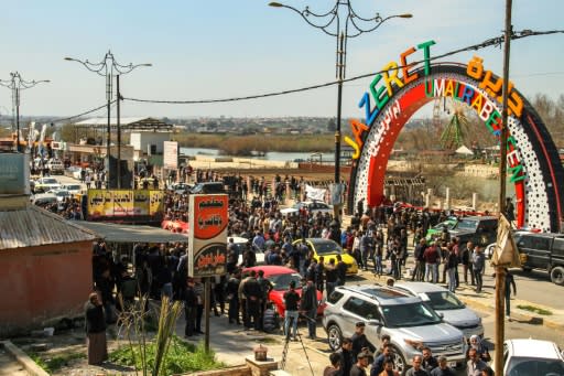 Iraqis demonstrate during a vigil in the northern Iraqi city of Mosul a day after a ferry packed with families celebrating Kurdish New Year capsized in the River Tigris killing 100 people