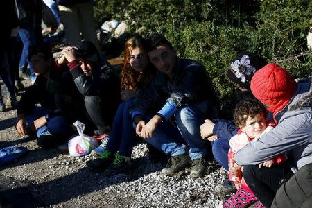 Syrian refugees wait on a roadside near a beach in the western Turkish coastal town of Dikili, Turkey, after Turkish Gendarmes prevented them from sailing off for the Greek island of Lesbos by dinghies, March 5, 2016. REUTERS/Umit Bektas