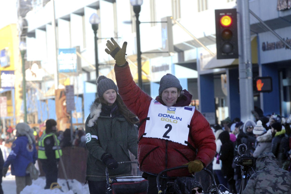 Musher Jessie Holmes of Brushkana, Alaska, waves to the crowd during the Iditarod Trail Sled Dog Race's ceremonial start in downtown Anchorage, Alaska, on Saturday, March 4, 2023. The smallest field ever of only 33 mushers will start the competitive portion of the Iditarod Sunday, March 5, 2023, in Willow, Alaska. (AP Photo/Mark Thiessen)