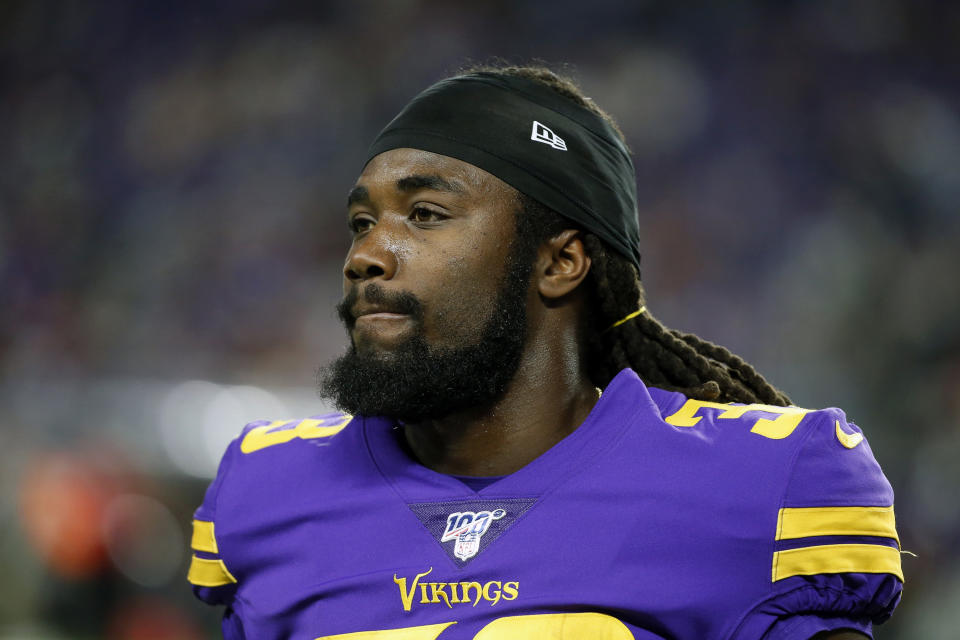 FILE - In this Oct. 24 2019, file photo, Minnesota Vikings running back Dalvin Cook walks on the field before an NFL football game against the Washington Redskins in Minneapolis. The Vikings have centered their offense around running back Dalvin Cook and praised him at every turn, but now the bill has come due. Cook is holding out of team activities until he has a new contract. (AP Photo/Bruce Kluckhohn, FIle)