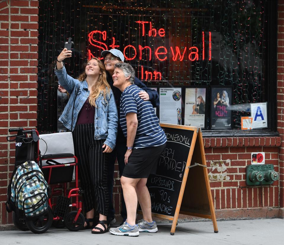 Kelly DeWeese takes a selfie in front of the the Stonewall Inn with her two moms, Linda Quinn and Karen DeWeese while they were visiting from Calif.