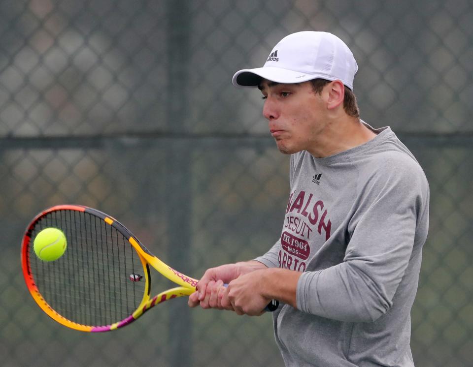 Walsh Jesuit's Michael Ulrich sends a shot back over the net during a doubles tennis match against Brecksville on Wednesday.