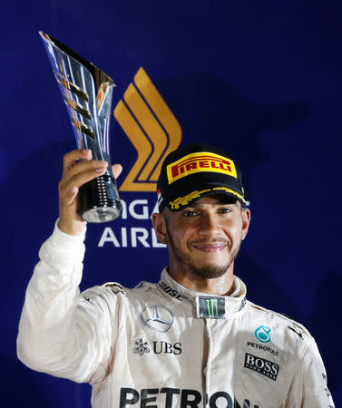 Formula One - F1 - Singapore Grand Prix - Marina Bay, Singapore- 18/9/16 Mercedes' Lewis Hamilton of Britain celebrates on the podium. REUTERS/Edgar Su