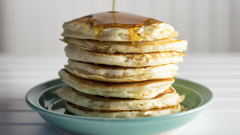 Syrup pouring onto pancakes