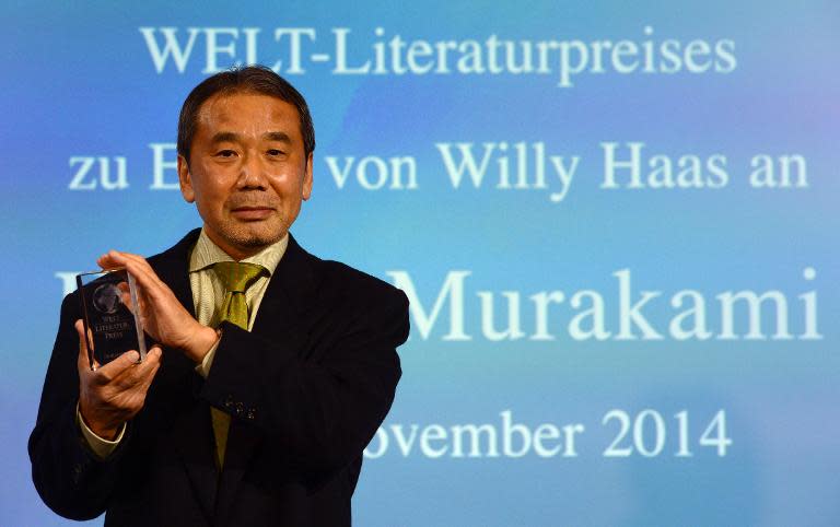 Japanese novelist Haruki Murakami poses with his trophy prior to an award ceremony for the Germany&#39;s Welt Literature Prize bestowed by the German daily Die Welt, in Berlin on November 7, 2014