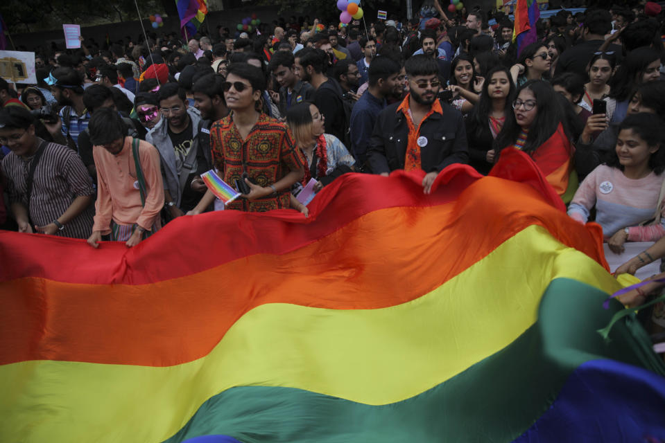 Members of the LGBTQ community and their supporters display a rainbow flag during the annual Delhi Queer Pride parade in New Delhi, India, Sunday, Nov.24, 2019. More than 1,000 members of the LGBTQ community and their supporters marched through New Delhi to celebrate India’s sexual diversity, which they say is progressing but still has a long way to go to become a more accepting place for them. (AP Photo/ Rishabh R. Jain)