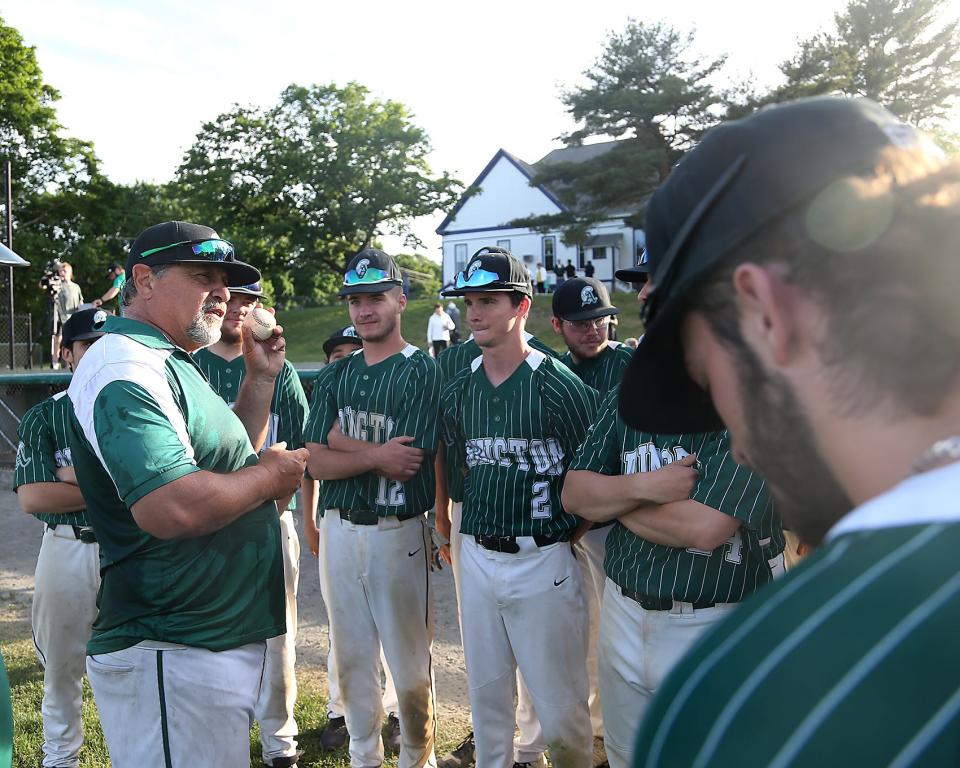 Head coach Steve Perakslis holds up the game ball while talking to his team following their win over Norwell at Frolio Field in Abington on Wednesday, May 25, 2022. Abington head coach Steve Perakslis won his 300th win with the victory.