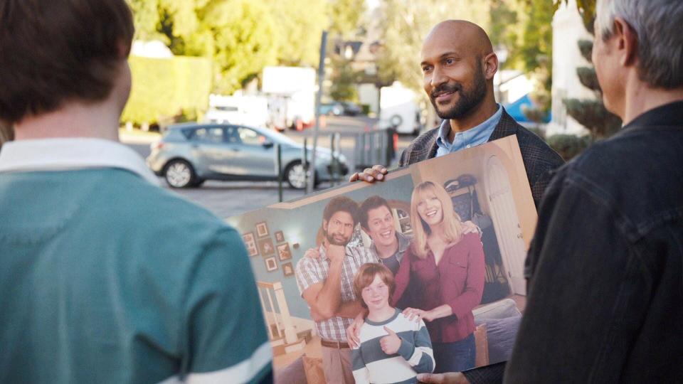 Keegan-Michael Key holds up a photo depicting the fake show at the center of "Reboot."