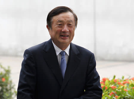 FILE PHOTO: Huawei CEO and founder Ren Zhengfei walks inside Huawei's headquarters in the southern Chinese city of Shenzhen, Guangdong province, in this October 16, 2013 file photo. REUTERS/Bobby Yip