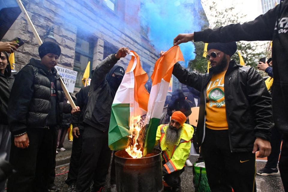 An Indian flag is burned during a protest outside India’s consulate in Canada (REUTERS)