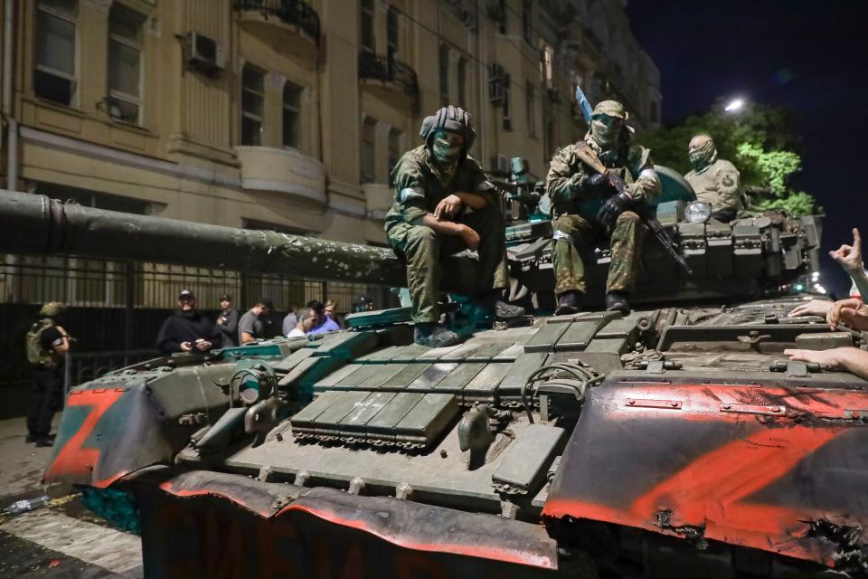 Membes of the Wagner Group military company sit atop of a tank on a street in Rostov-on-Don, Russia, Saturday, June 24, 2023.