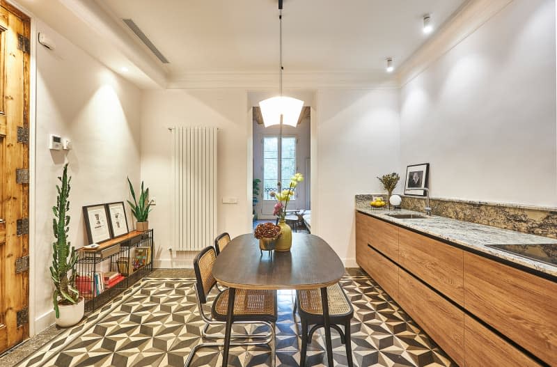 Oval dining table in kitchen area of Barcelona apartment.