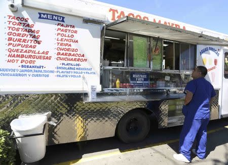 A voter registration sign is seen on a taco truck, as part of the U.S. Hispanic Chamber of Commerce's "Guac the Vote" campaign, in Houston, Texas, U.S. September 29, 2016. REUTERS/Trish Badger