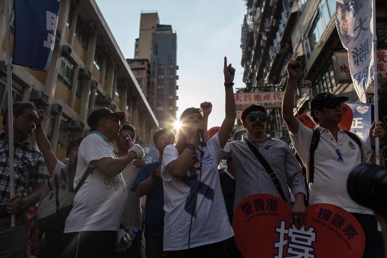 'Anti-Occupy' activists take part in a protest march near the 'Occupy' camp in the Mong Kok district of Hong Kong, on October 12, 2014