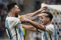 Argentina's Julian Alvarez, right, and Lionel Messi, left, celebrate their side's second goal during the World Cup round of 16 soccer match between Argentina and Australia at the Ahmad Bin Ali Stadium in Doha, Qatar, Saturday, Dec. 3, 2022. (AP Photo/Frank Augstein)