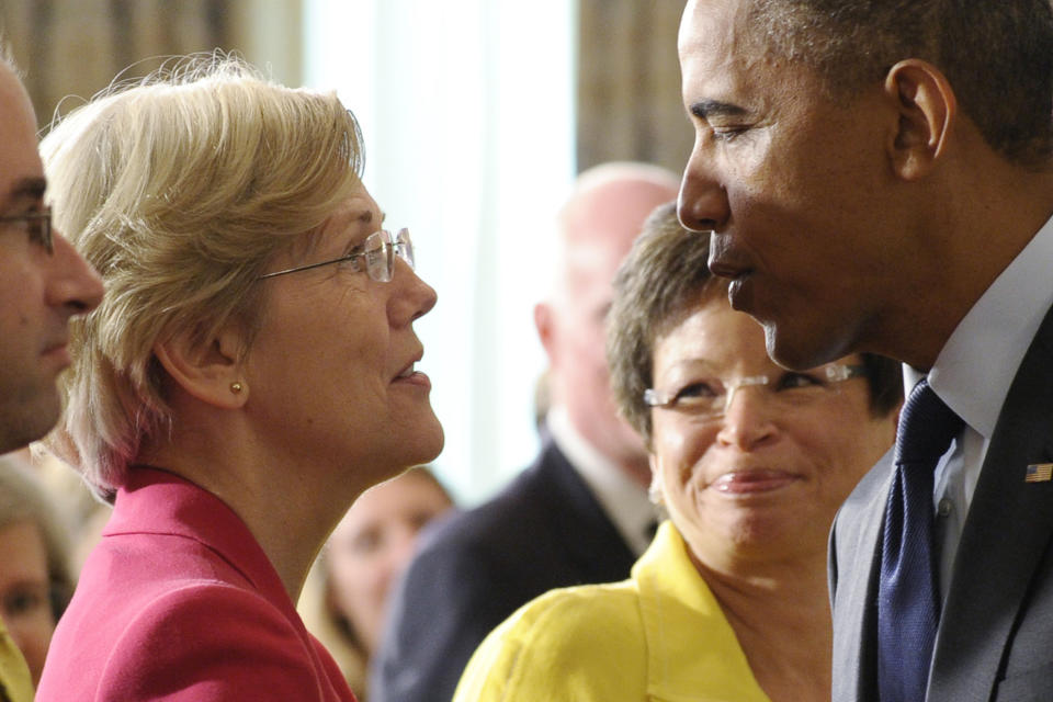 In this July 17, 2013 file photo, Sen. Elizabeth Warren, D-Mass., left, talks with President Barack Obama following a statement with Richard Cordray, the new director of the Consumer Financial Protection Bureau, in the State Dining Room of the White House in Washington. As she enters her second year in Congress in 2014, Warren told The Associated Press she's focused on improving the economic futures of American families by reigning in student debt, easing what she calls the nation's retirement crisis, and doubling funding for federal research programs. (AP Photo/Susan Walsh, File)
