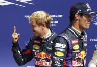 Red Bull Formula One driver Sebastian Vettel of Germany celebrates taking the pole position, as team mate Mark Webber (R) of Australia walks past, after the qualifying session of the Italian F1 Grand Prix at the Monza circuit September 7, 2013. Formula One world champion Vettel seized pole position for the Italian Grand Prix in a Red Bull one-two in qualifying on Saturday, with Webber lining up alongside on the front row. REUTERS/Max Rossi (ITALY - Tags: SPORT MOTORSPORT F1 TPX IMAGES OF THE DAY)