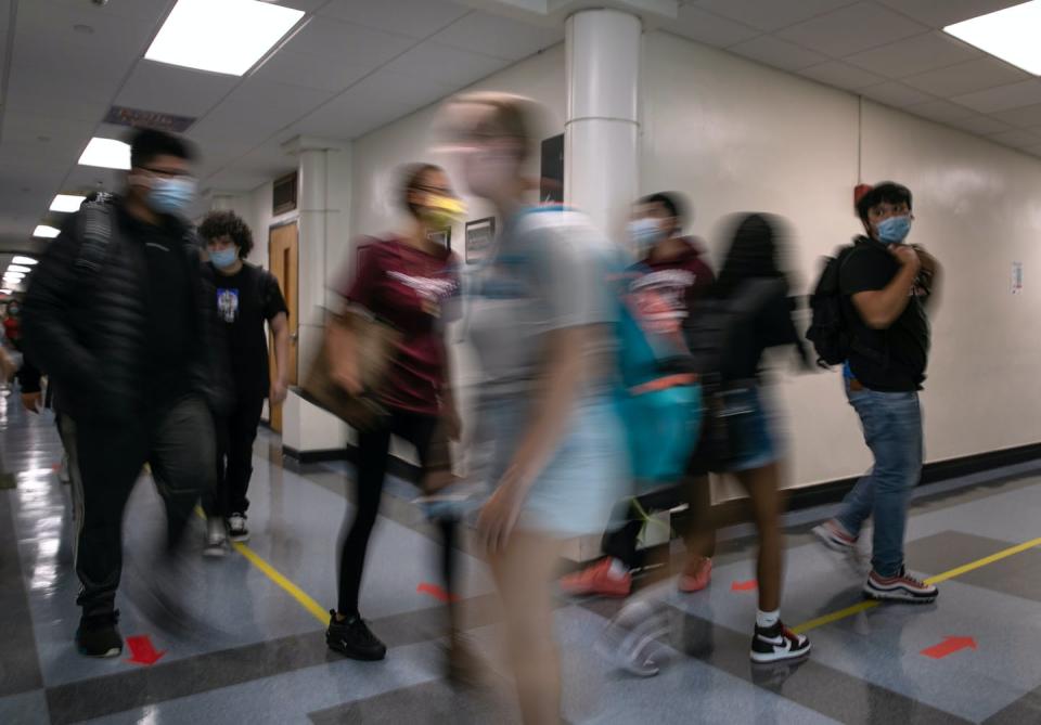 High school students pass each other in hallway