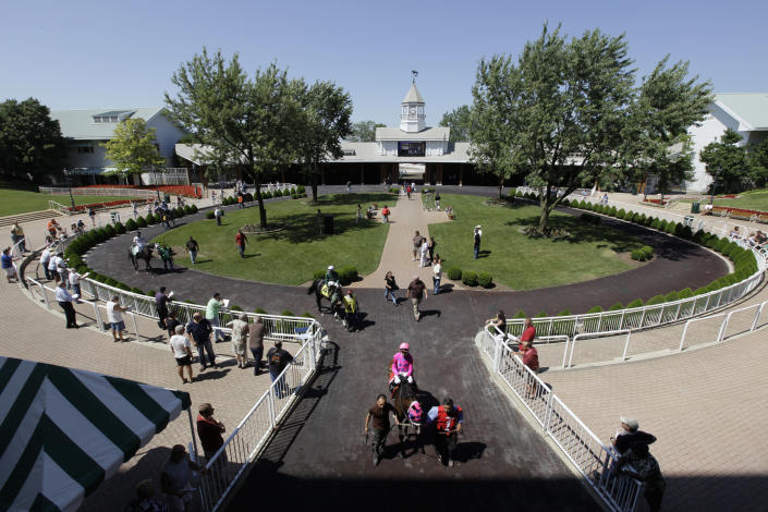 FILE - In this July 16, 2010, file photo, orses and jockeys make their way from the paddock to the race track at Arlington Park in Arlington Heights, Ill. The racetrack is expected to close after the completion of racing on Sept. 25, with ownership taking bids for the future of the land. (AP Photo/M. Spencer Green)