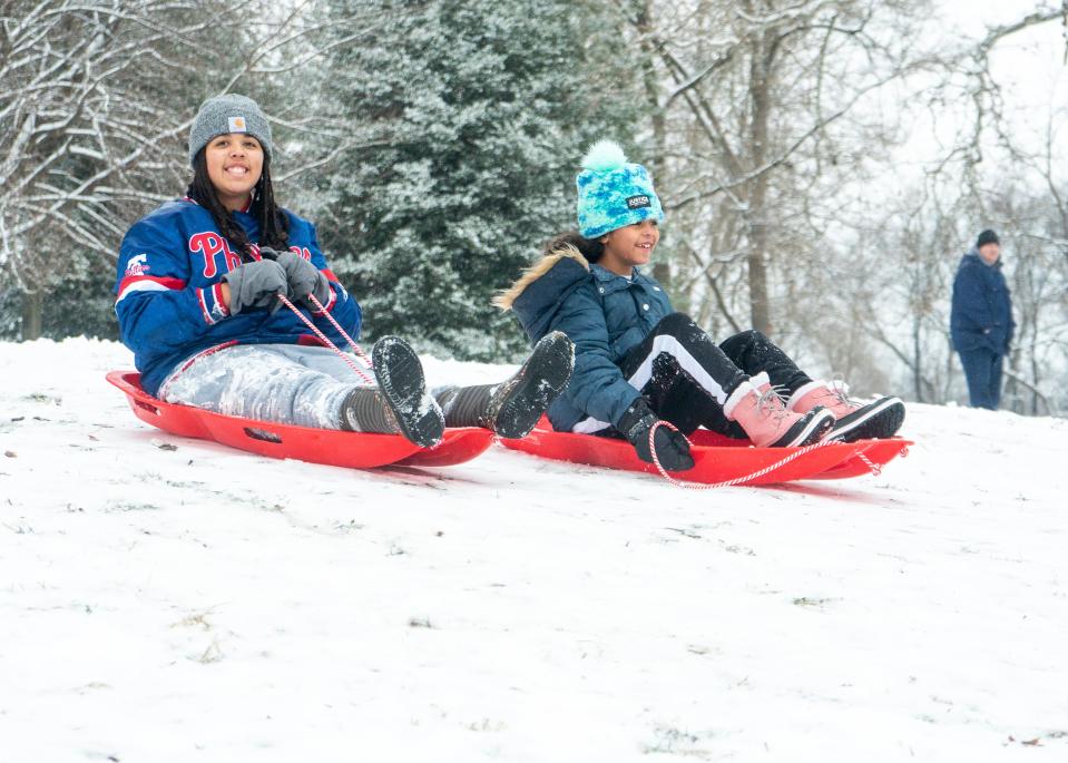 Hazel Gibson (10), left, and Devlin Gibson (8), right, from the sled down the hill by the old Bolton Manson after last night's snowstorm left a few inches of snow in the Holly Hill neighborhood of Levittown on Tuesday, Jan. 16, 2024.

Daniella Heminghaus | Bucks County Courier Times